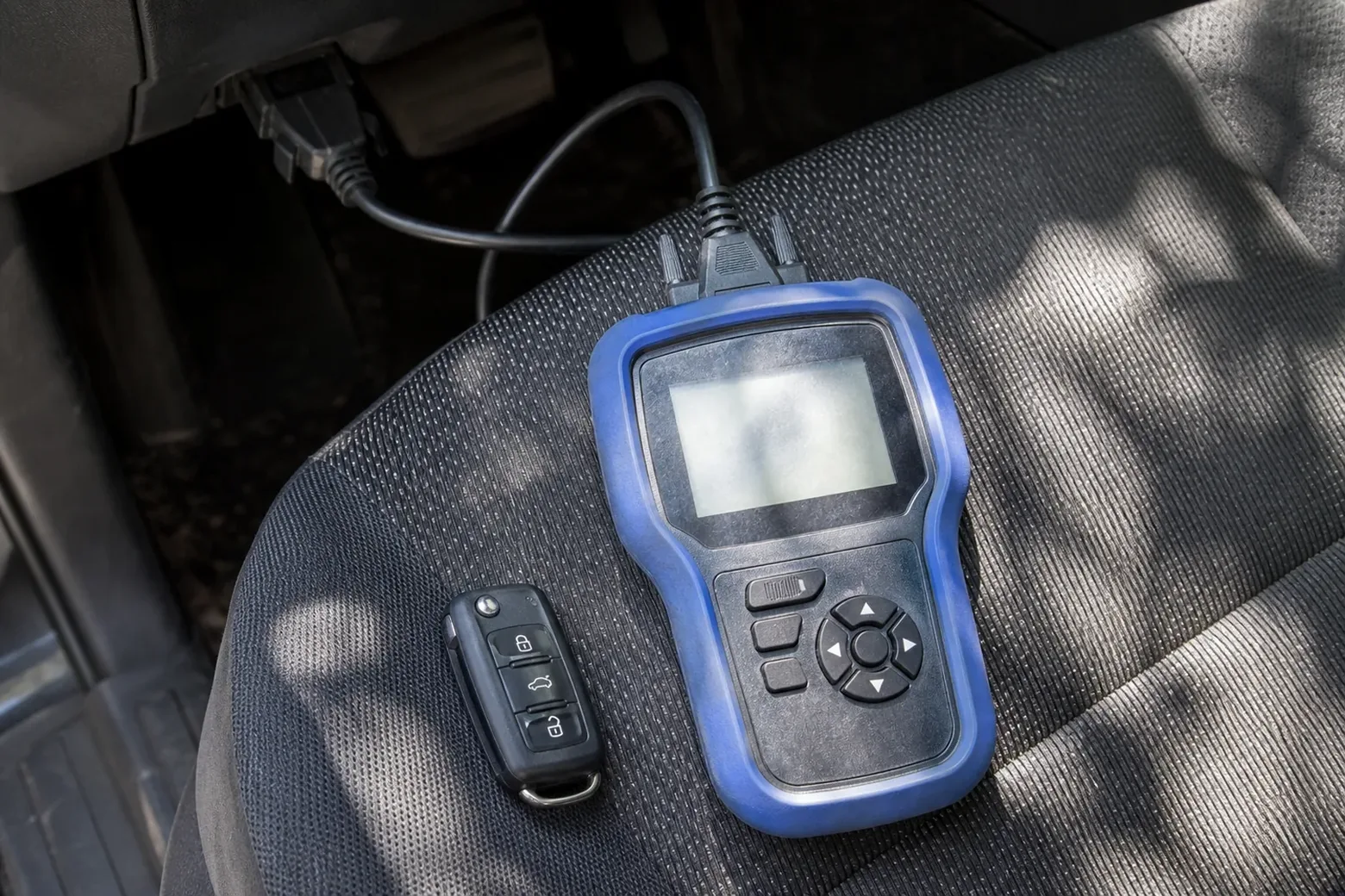Car key programmer plugged into the OBD port, Denton, TX